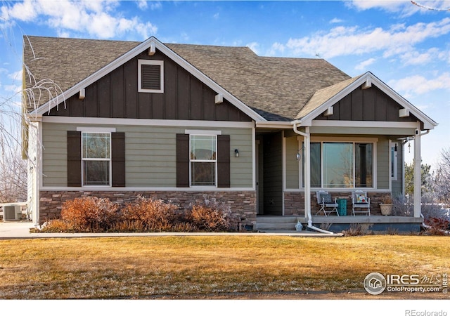 craftsman inspired home with covered porch, cooling unit, and a front yard