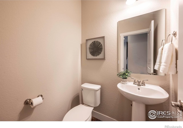 bathroom featuring a sink and toilet