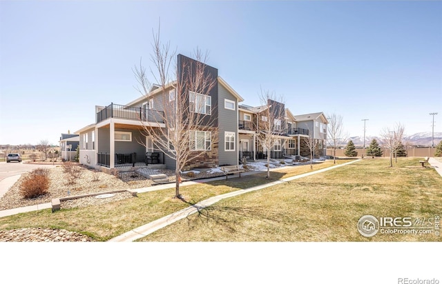 back of property featuring a yard and a residential view