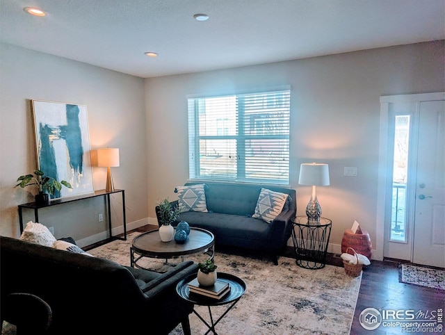 living room featuring dark wood-style floors, recessed lighting, and baseboards