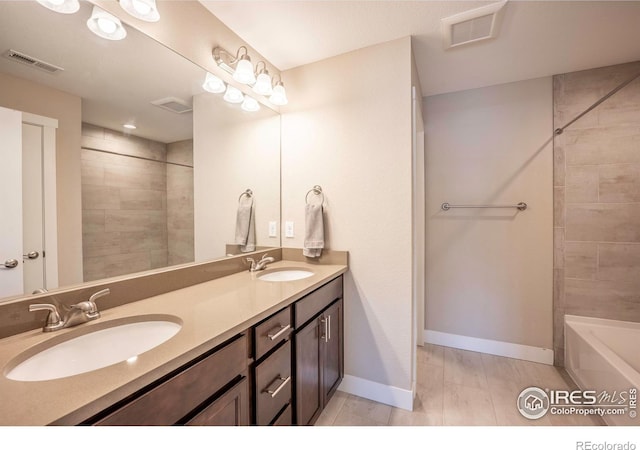 full bathroom featuring visible vents, a sink, and baseboards