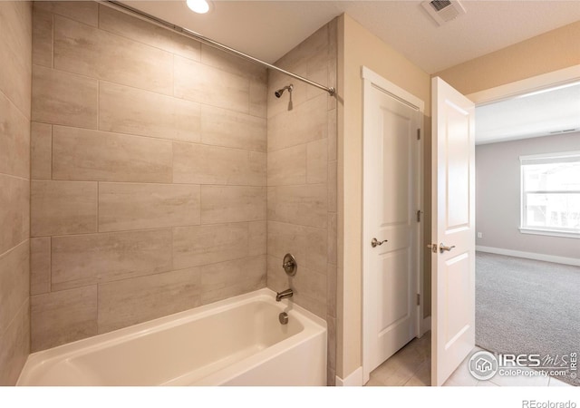 bathroom featuring visible vents, shower / bathing tub combination, and baseboards