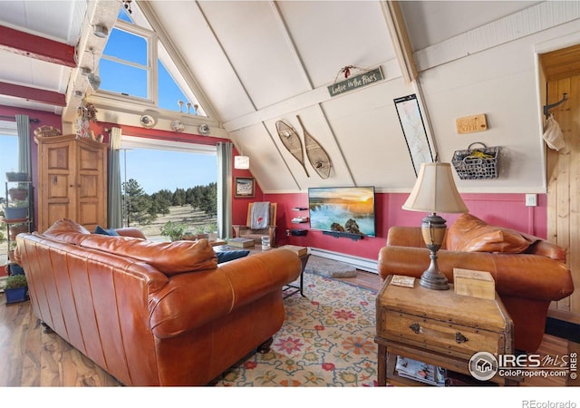 interior space featuring vaulted ceiling with beams, light hardwood / wood-style flooring, and baseboard heating