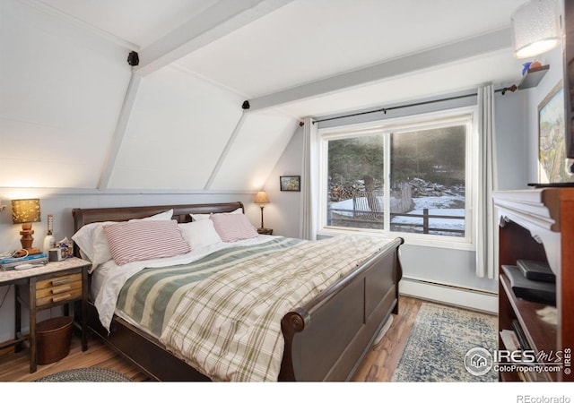 bedroom with wood-type flooring, a baseboard radiator, and vaulted ceiling