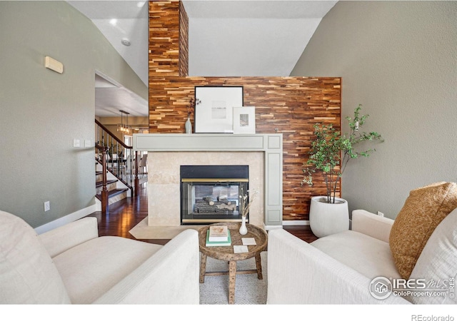 living room with a fireplace, high vaulted ceiling, and hardwood / wood-style flooring