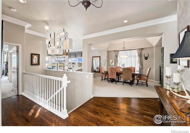 dining area featuring a chandelier, ornamental molding, and hardwood / wood-style flooring