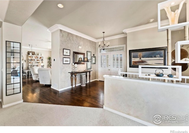 kitchen featuring french doors, dark wood-type flooring, a notable chandelier, decorative light fixtures, and ornamental molding