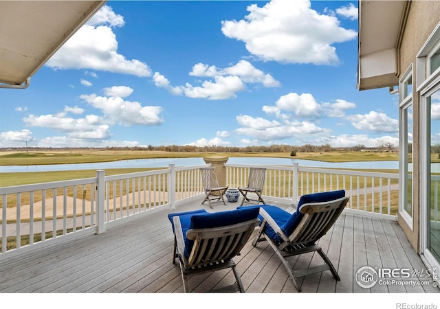 wooden terrace featuring a water view