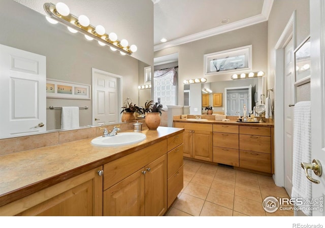 bathroom with tile patterned flooring, vanity, and crown molding