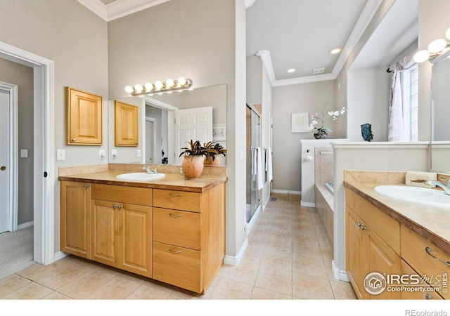 bathroom with plus walk in shower, vanity, tile patterned floors, and ornamental molding