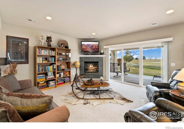 carpeted living room with a fireplace