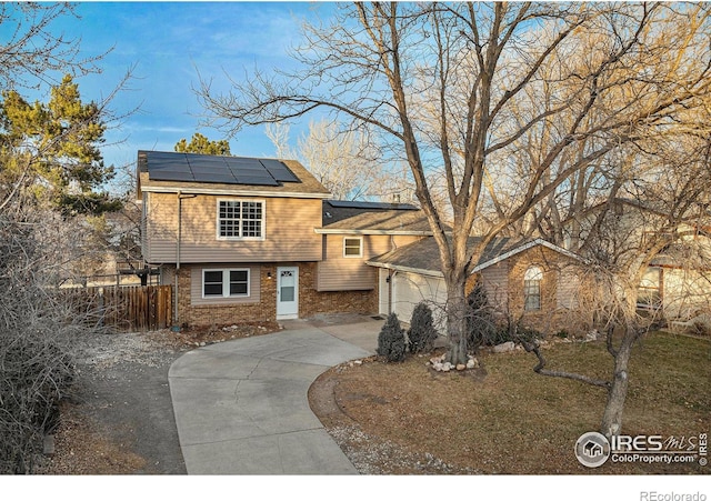 view of front of house with solar panels and a garage