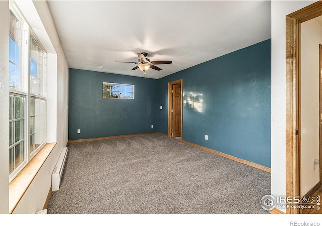 spare room featuring baseboard heating, ceiling fan, and carpet