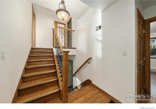 stairs featuring hardwood / wood-style floors