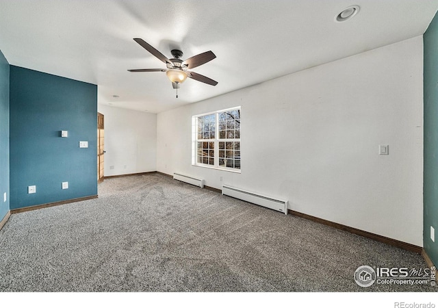 carpeted empty room featuring ceiling fan and a baseboard heating unit