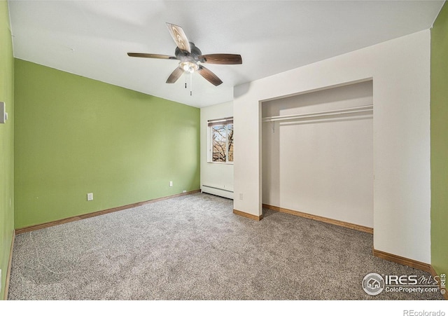 unfurnished bedroom featuring baseboard heating, ceiling fan, a closet, and carpet floors