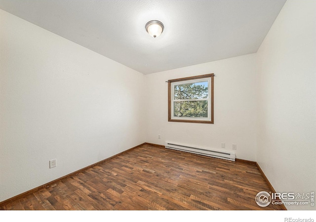 unfurnished room featuring a baseboard radiator and dark wood-type flooring