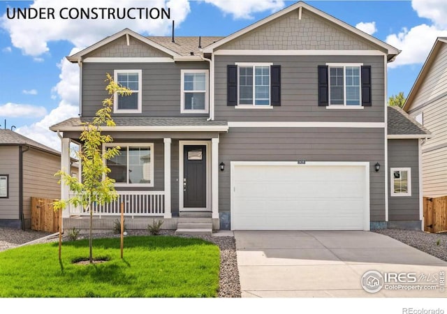 craftsman inspired home featuring a front lawn, covered porch, and a garage