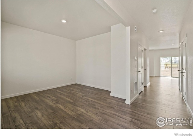 empty room featuring dark wood-type flooring