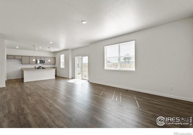 unfurnished living room featuring dark wood-type flooring