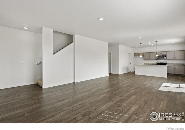 unfurnished living room featuring dark hardwood / wood-style floors