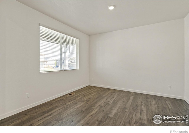 empty room featuring dark hardwood / wood-style flooring