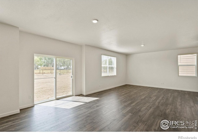 unfurnished room with dark hardwood / wood-style floors