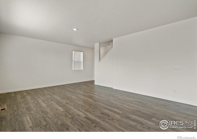 spare room with dark hardwood / wood-style flooring