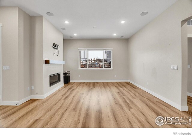 unfurnished living room featuring light wood-type flooring