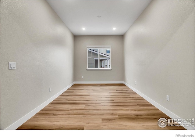 unfurnished room with light wood-type flooring