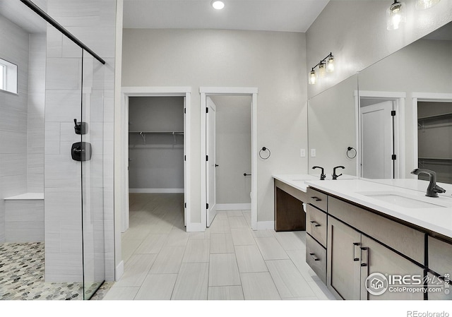 bathroom featuring vanity and tiled shower