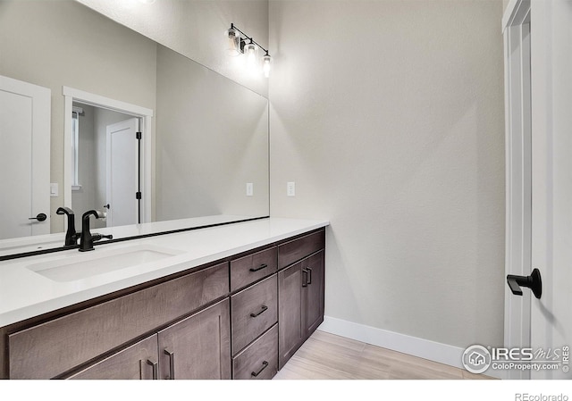 bathroom featuring hardwood / wood-style floors and vanity