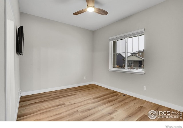 empty room featuring light hardwood / wood-style flooring and ceiling fan