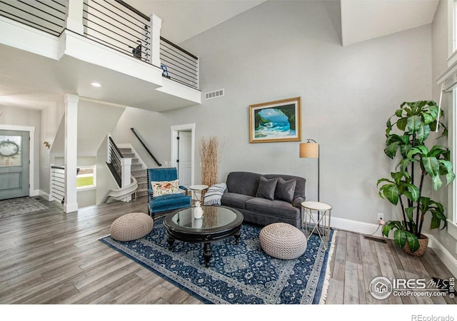 living room featuring a high ceiling and hardwood / wood-style floors