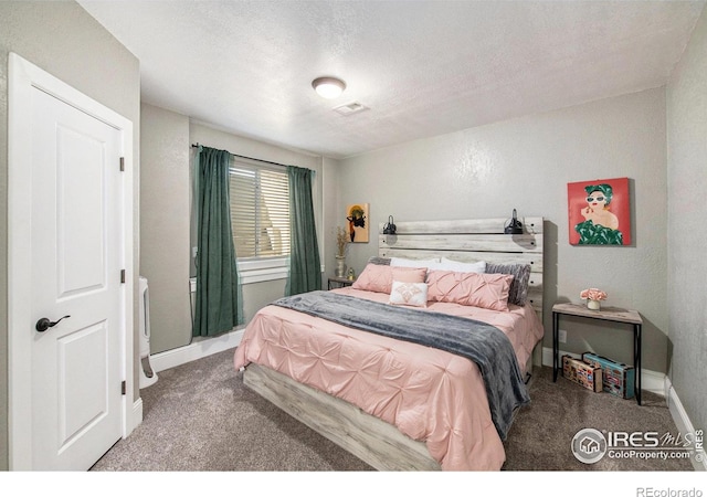 carpeted bedroom with a textured ceiling