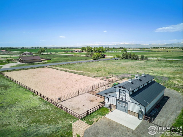 birds eye view of property with a mountain view and a rural view