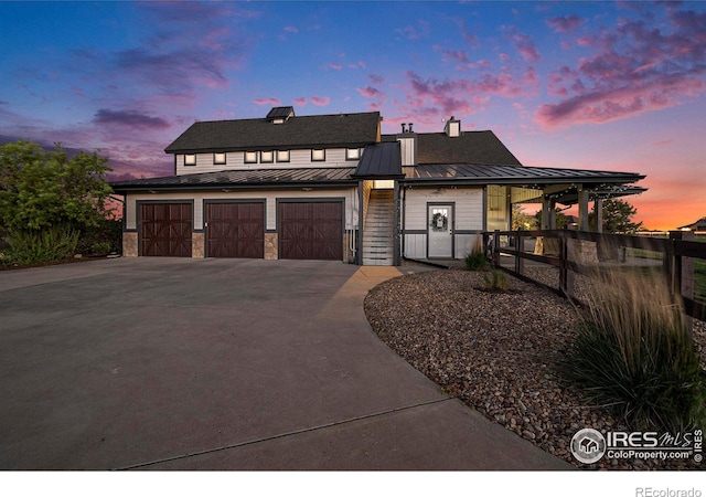37001 Soaring Eagle Cir, Severance, CO 80550 - modern farmhouse featuring a standing seam roof, concrete driveway, a metal roof, and a garage