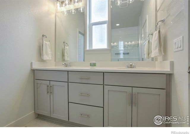 bathroom featuring a shower and vanity