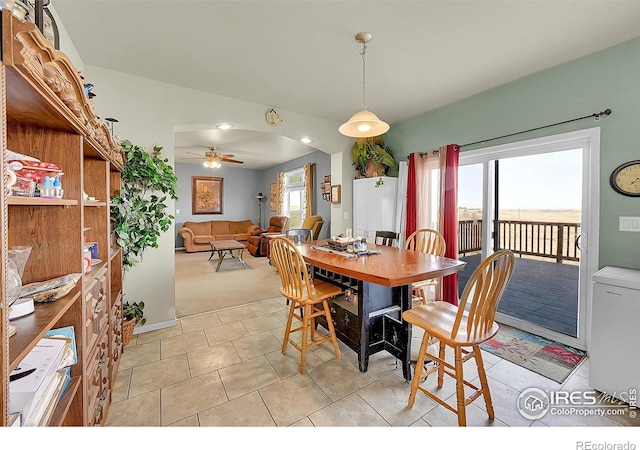 tiled dining area with ceiling fan