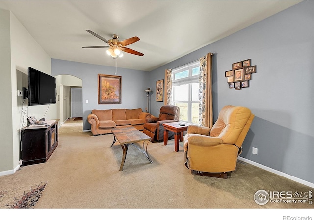 carpeted living room with ceiling fan