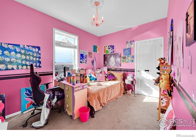 carpeted bedroom featuring a notable chandelier