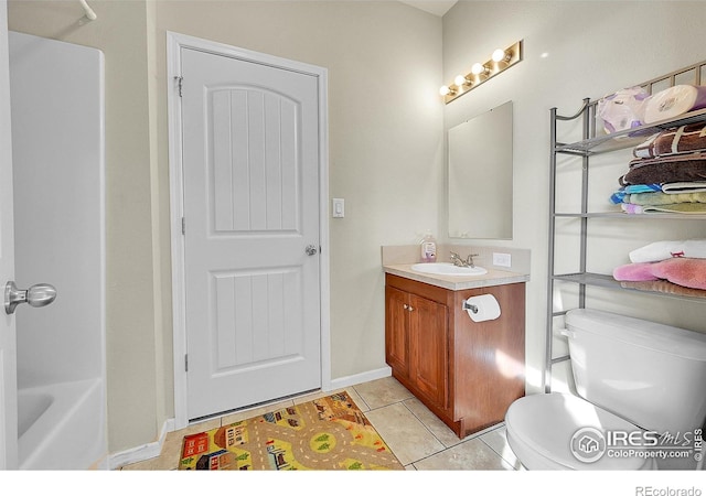 bathroom with tile patterned floors, vanity, and toilet