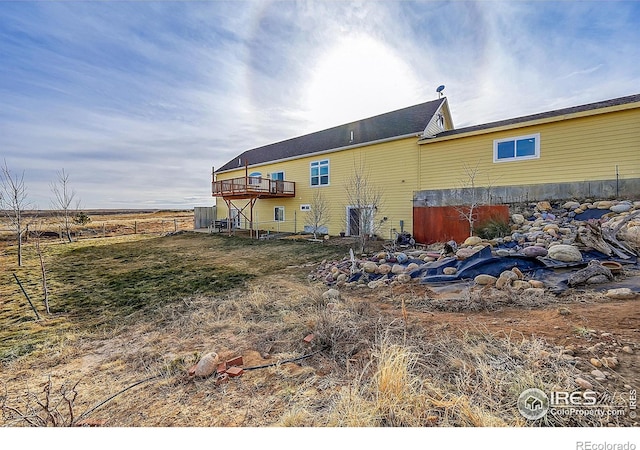 back of house featuring a wooden deck