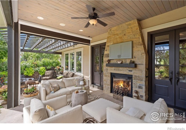 exterior space featuring ceiling fan, an outdoor stone fireplace, wooden ceiling, and french doors