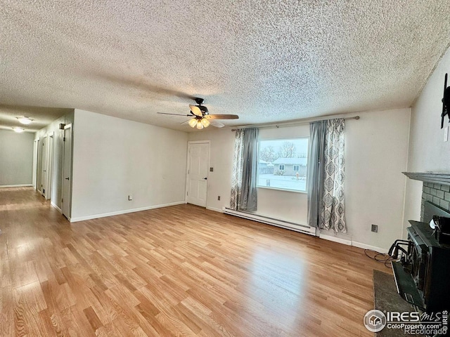 unfurnished living room with ceiling fan, light hardwood / wood-style floors, a textured ceiling, and a baseboard radiator