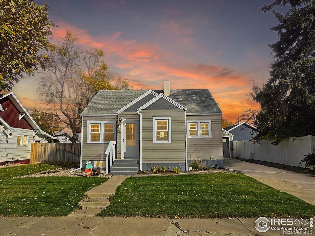 bungalow-style house featuring a yard