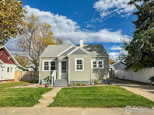 bungalow-style home with a front lawn