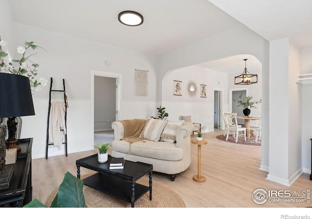 living room with hardwood / wood-style flooring and an inviting chandelier