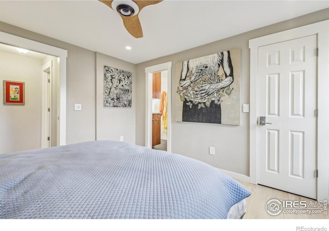 bedroom with ensuite bath and ceiling fan