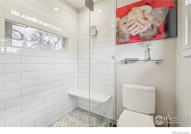 bathroom with an enclosed shower and toilet